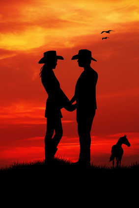 cowboy riding at sunset